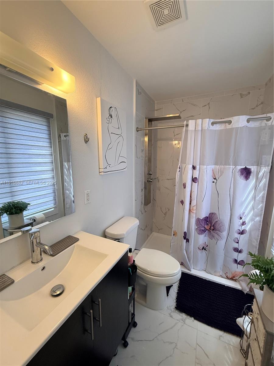 25855 Southwest 139th Court Homestead, FL 33032 - Photo 19 of 23 a bathroom with a sink toilet and shower