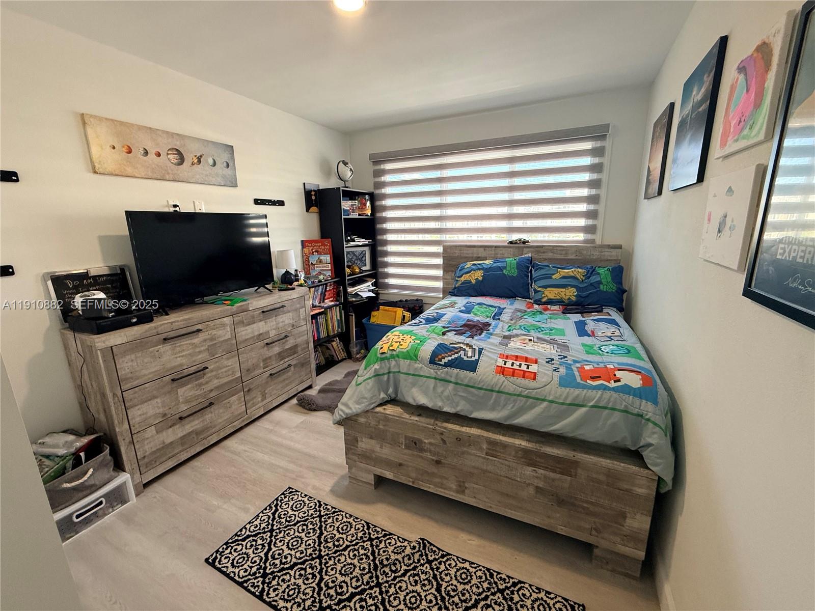 25855 Southwest 139th Court Homestead, FL 33032 - Photo 20 of 23 a bedroom with a bed and flat screen tv