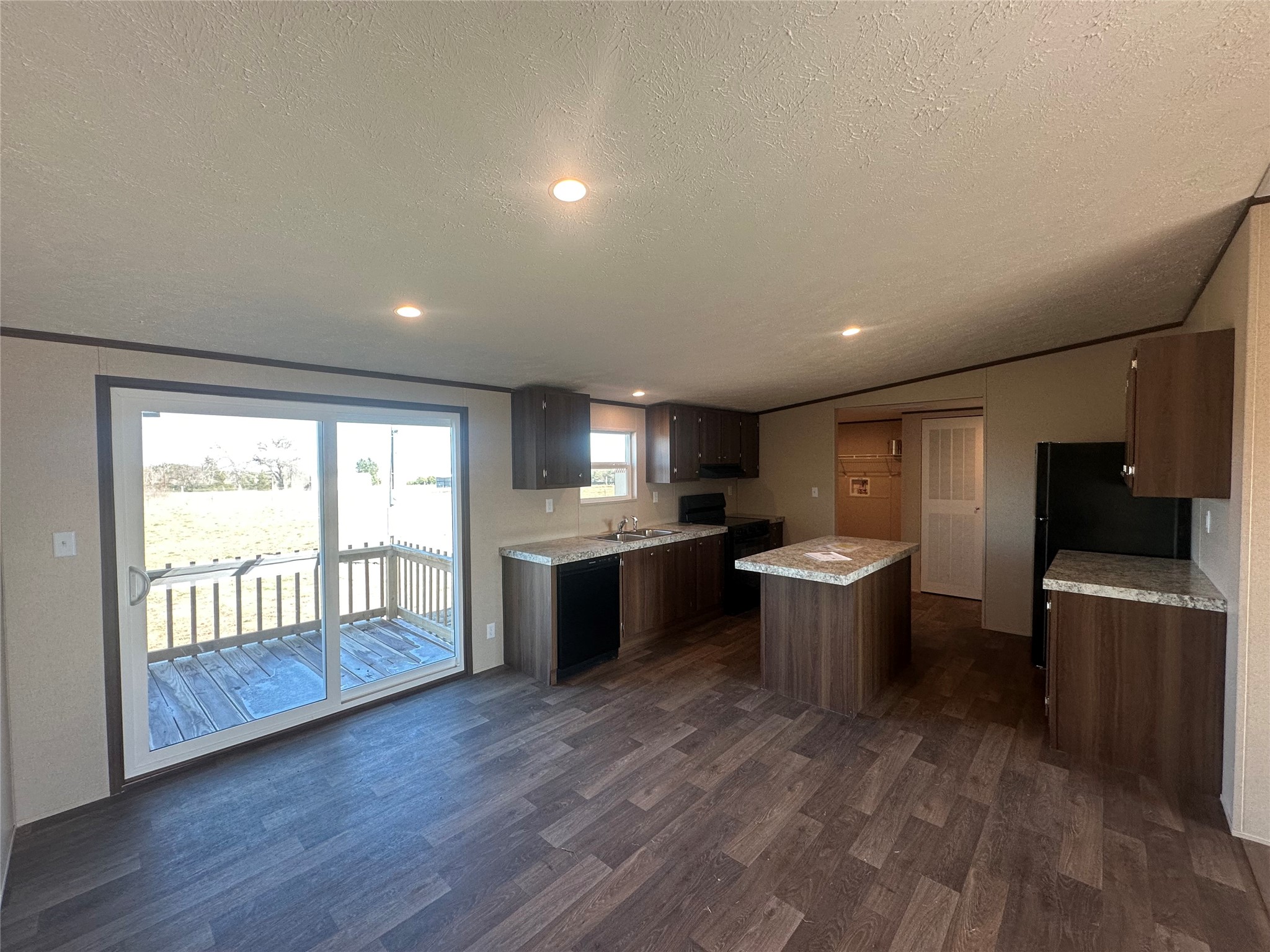 873 Golden Buffalo, TX 75831 - Photo 3 of 12 a large kitchen with a large counter top a sink stainless steel appliances and cabinets