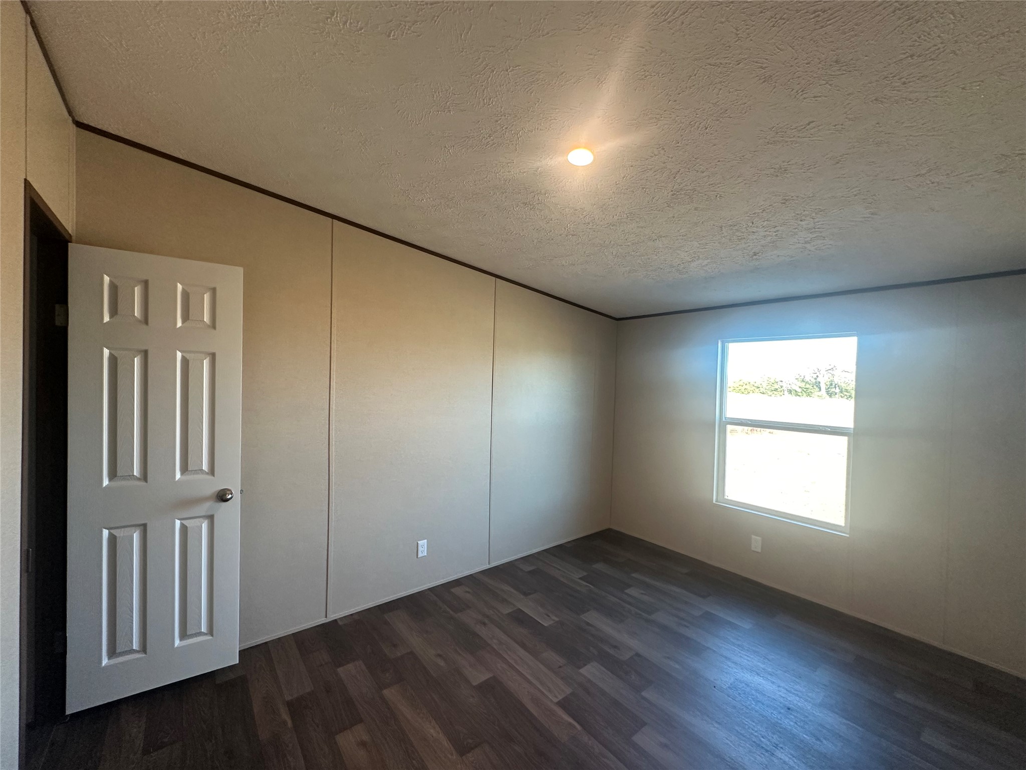 873 Golden Buffalo, TX 75831 - Photo 8 of 12 an empty room with wooden floor and windows