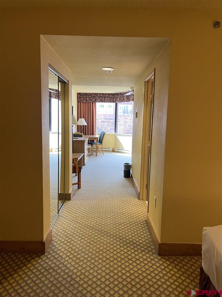 6 Emmons Road, Unit 269 Crested Butte, CO 81225 - Photo 6 of 18 a bedroom with a bed and wooden floor