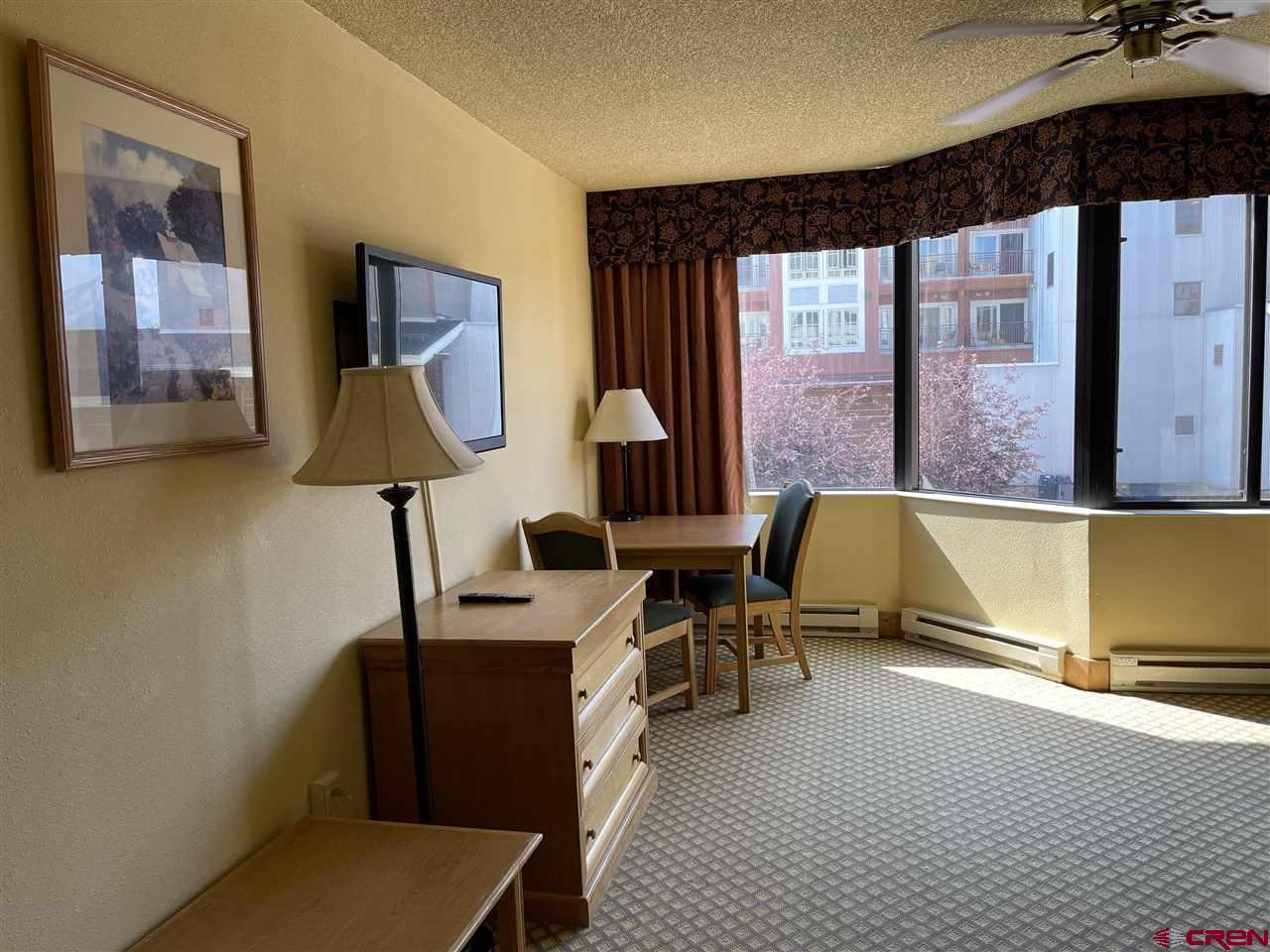 6 Emmons Road, Unit 269 Crested Butte, CO 81225 - Photo 9 of 18 a living room with furniture and a lamp