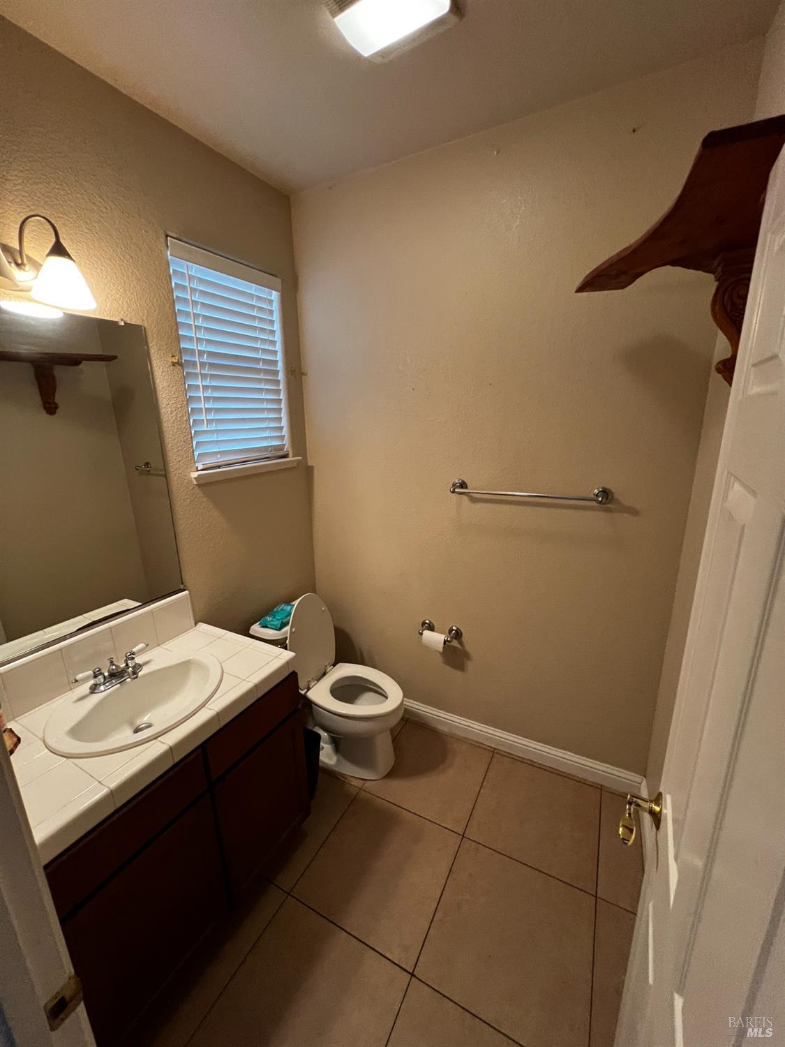 40 Curtis Court Bay Point, CA 94565 - Photo 11 of 18 a bathroom with a toilet sink and mirror