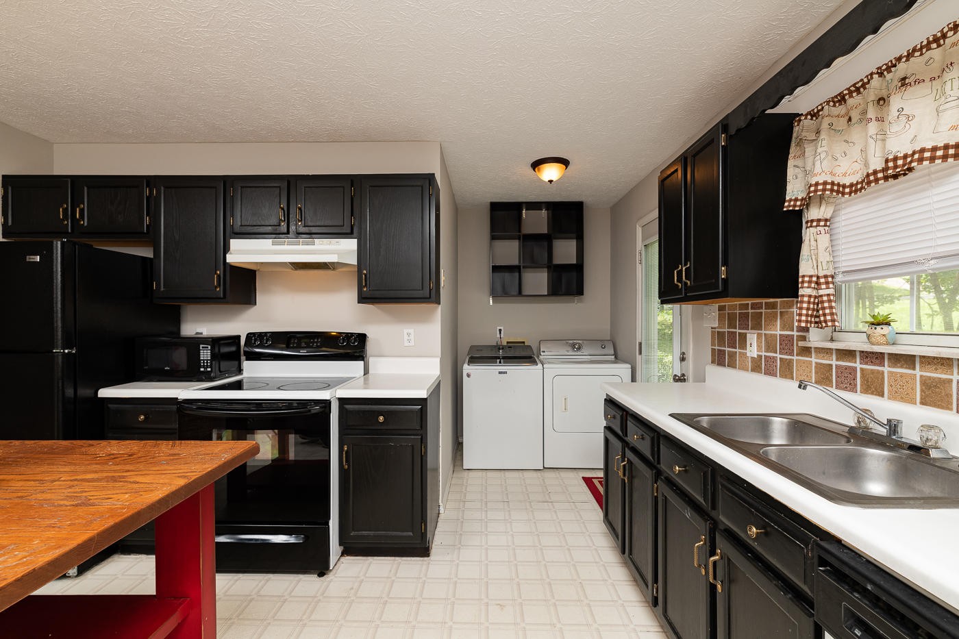 3508 Wexgate Road Knoxville, TN 37931 - Photo 7 of 17 a kitchen with a sink stove and cabinets