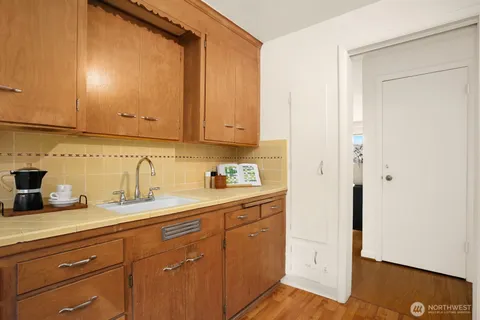a view of a sink a mirror and cabinets
