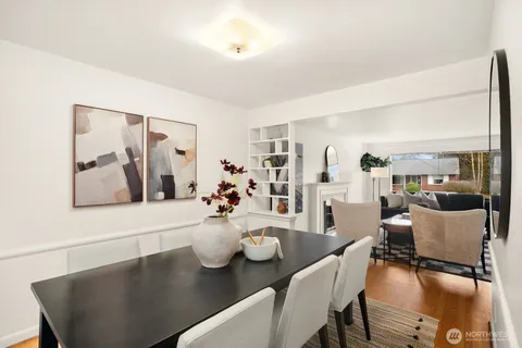 a dining room with furniture and wooden floor