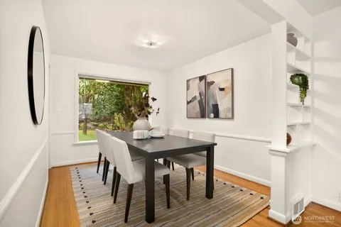 a view of a dining room with furniture window and wooden floor