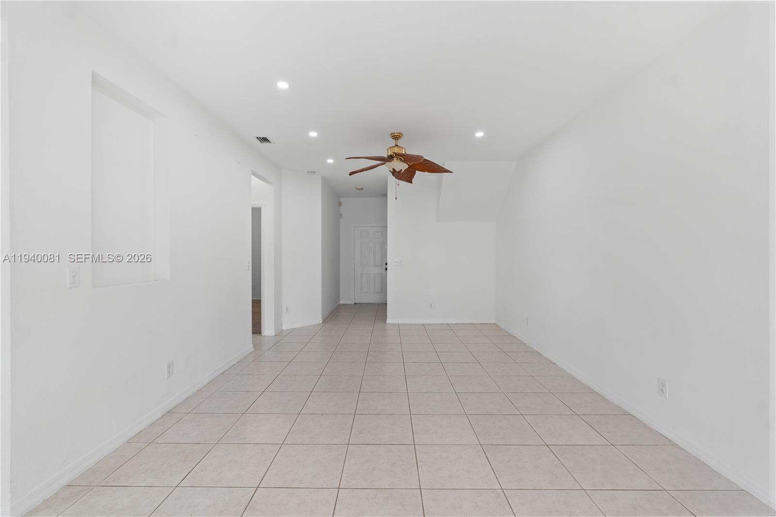 1564 Southwest 2nd Street Homestead, FL 33030 - Photo 11 of 29 a view of a livingroom with a ceiling fan and window