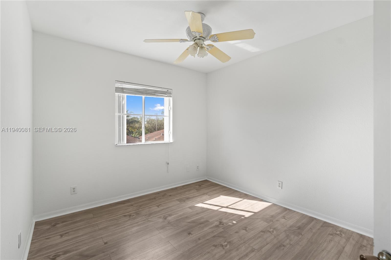 1564 Southwest 2nd Street Homestead, FL 33030 - Photo 25 of 29 an empty room with a window and a ceiling fan