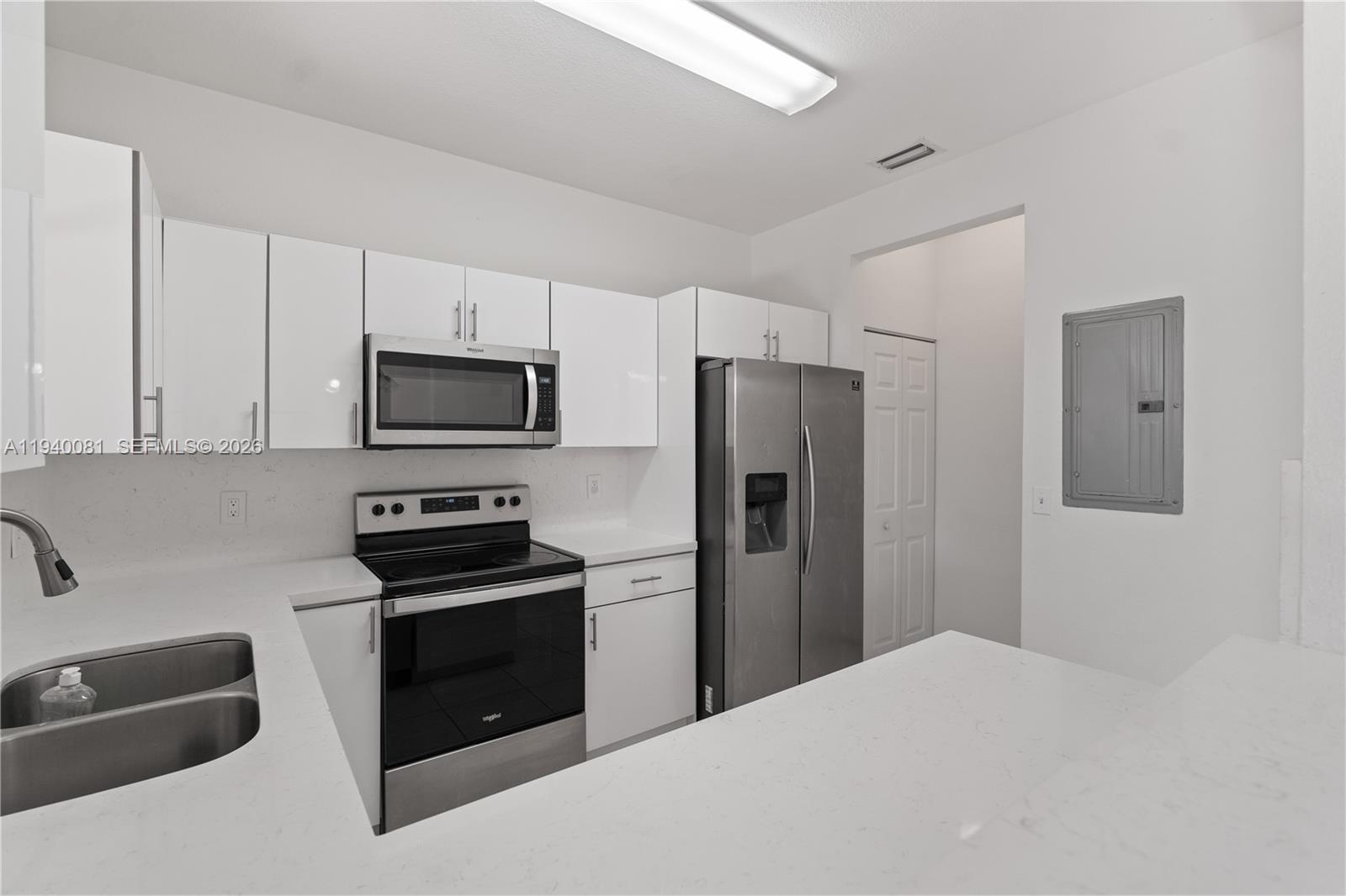 1564 Southwest 2nd Street Homestead, FL 33030 - Photo 10 of 29 a kitchen with a refrigerator stove and microwave