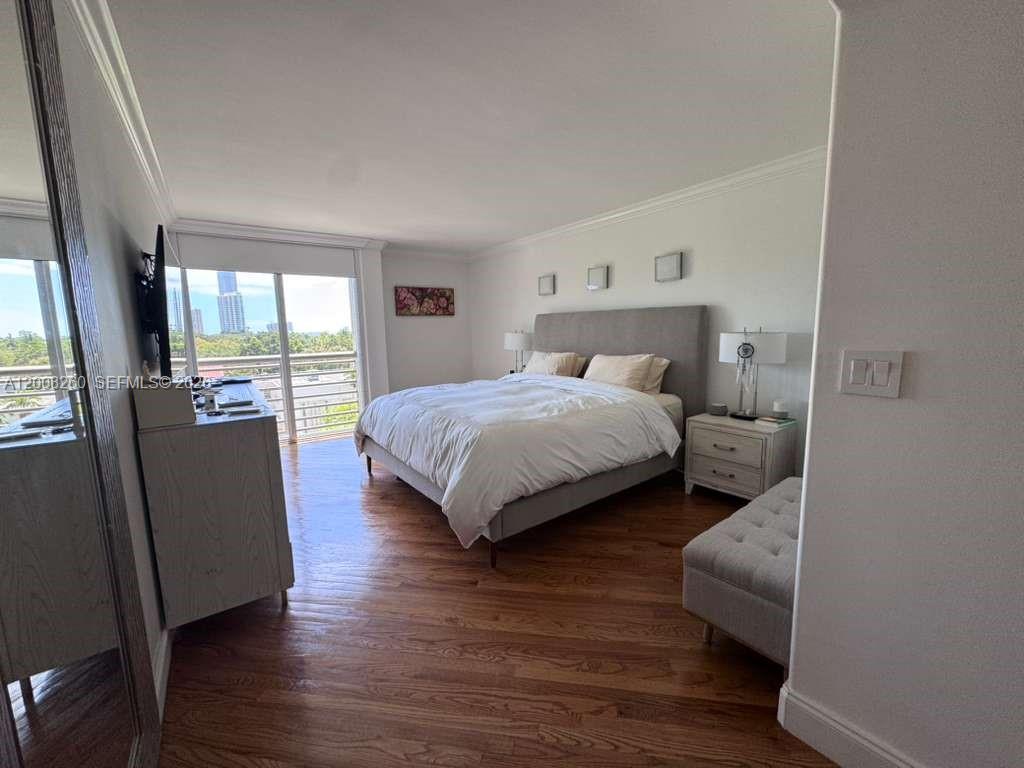 2400 Southwest 3rd Avenue, Unit 601 Miami, FL 33129 - Photo 11 of 21 a bedroom with a bed and wooden floor