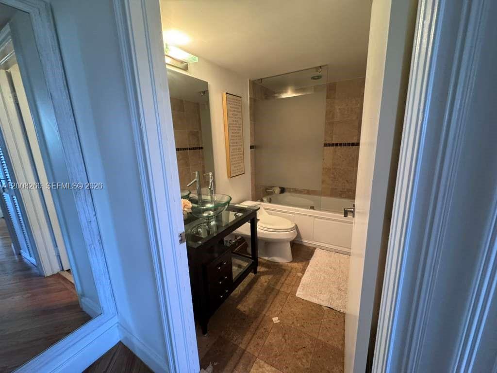 2400 Southwest 3rd Avenue, Unit 601 Miami, FL 33129 - Photo 16 of 21 a bathroom with a double vanity sink toilet and shower