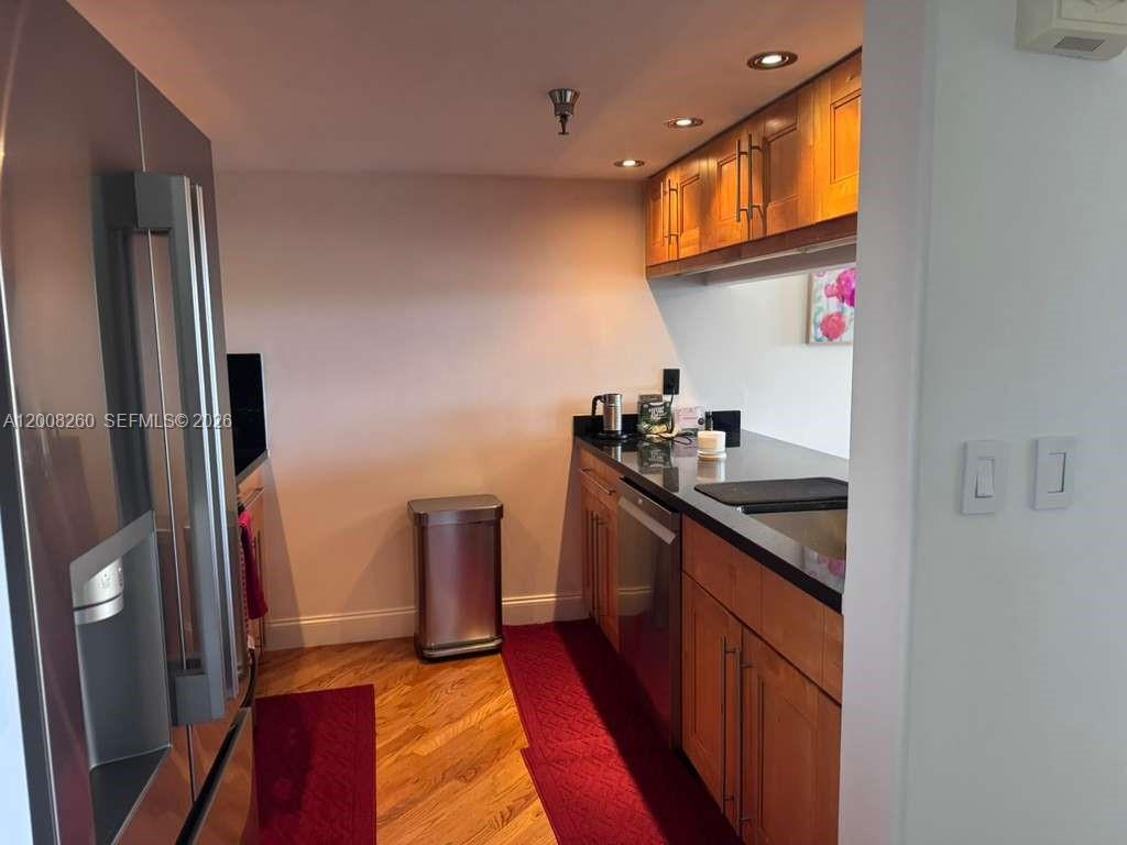 2400 Southwest 3rd Avenue, Unit 601 Miami, FL 33129 - Photo 3 of 21 a kitchen with stainless steel appliances granite countertop a refrigerator and a sink