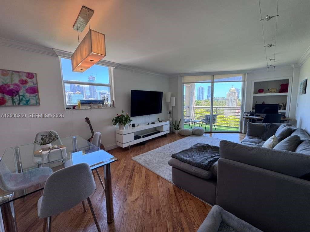 2400 Southwest 3rd Avenue, Unit 601 Miami, FL 33129 - Photo 10 of 21 a living room with furniture flat screen tv and a window