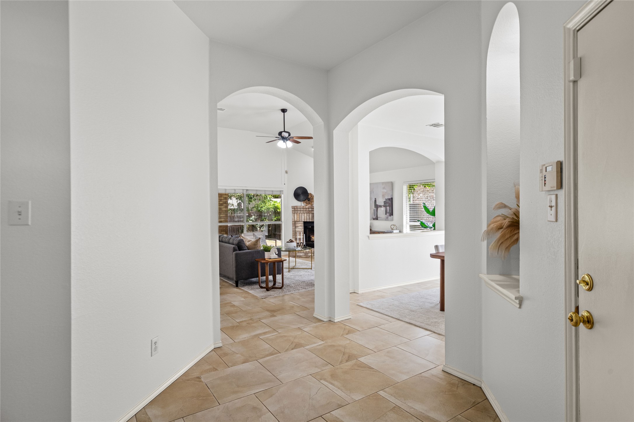 2920 Warwick Way Austin, TX 78748 - Photo 7 of 36 Enter through a grand arched foyer, revealing sun-drenched living areas with high ceilings and fireplace