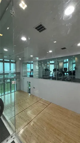 a view of a room with gym equipment and a large window