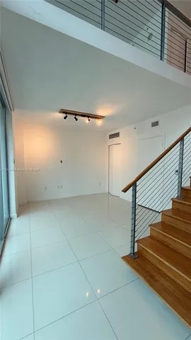 a view of a hallway with stairs