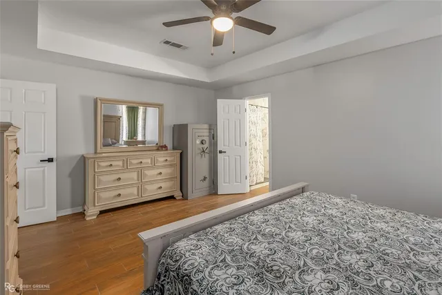 a spacious bedroom with a bed and a cabinets