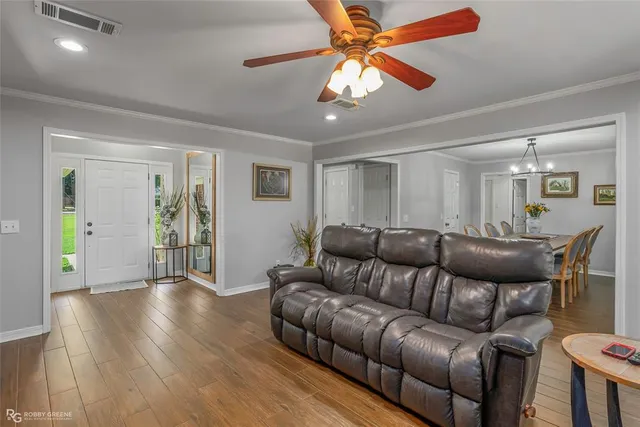 a living room with furniture and wooden floor