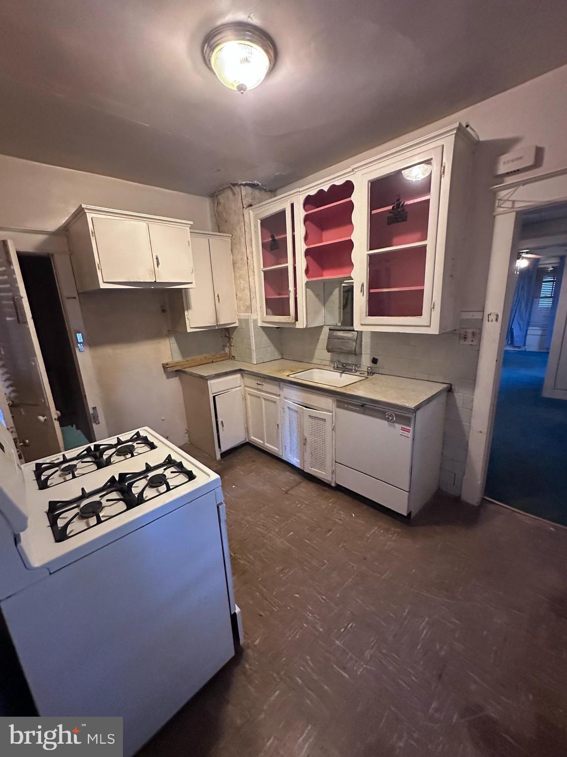 4719 Rittenhouse Street Riverdale, MD 20737 - Photo 5 of 15 a kitchen with stainless steel appliances a sink stove and cabinets