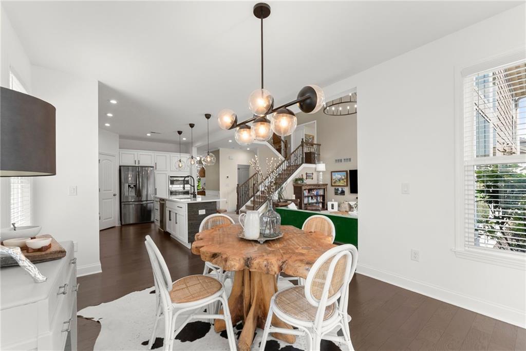 147 Michigan Circle Hoschton, GA 30548 - Photo 23 of 85 a view of a dining room with furniture and a chandelier