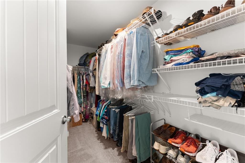 147 Michigan Circle Hoschton, GA 30548 - Photo 36 of 85 a view of walk in closet with clothes and shoes