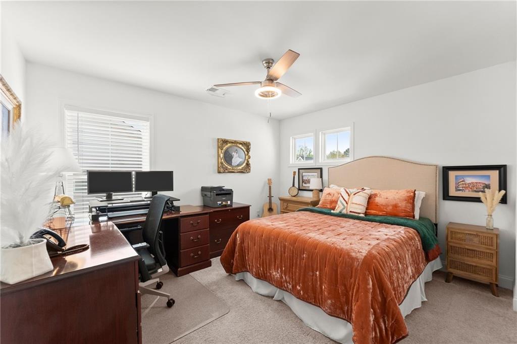 147 Michigan Circle Hoschton, GA 30548 - Photo 44 of 85 a bedroom with a bed and a desk