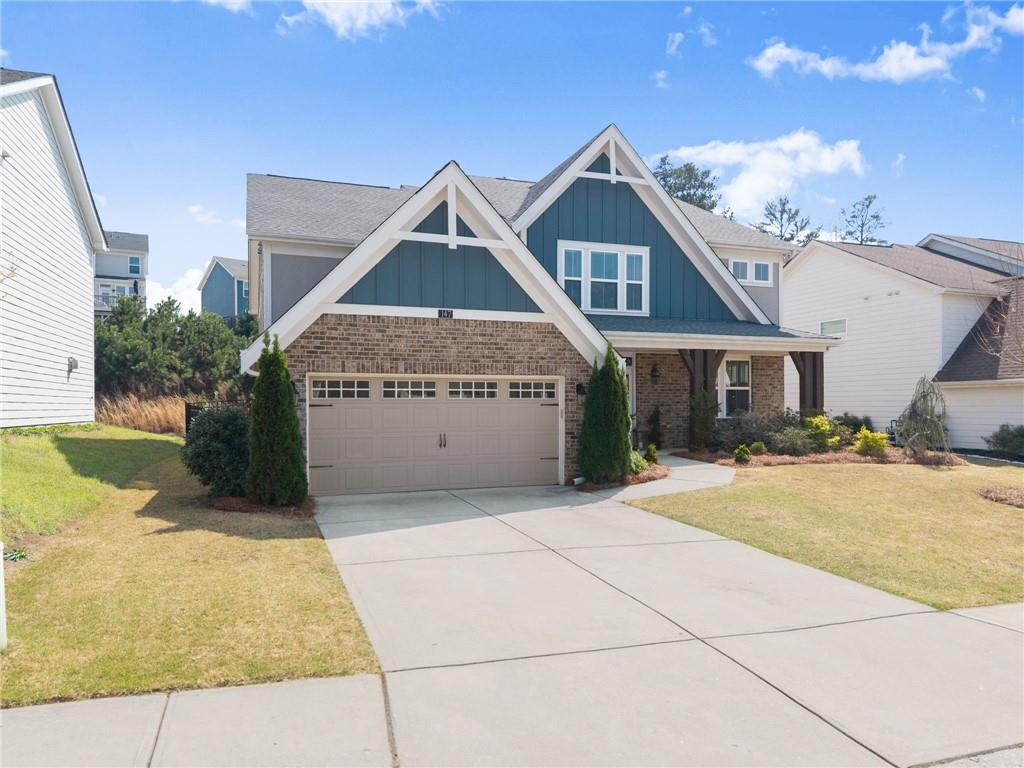 147 Michigan Circle Hoschton, GA 30548 - Photo 5 of 85 a front view of a house with a yard and garage