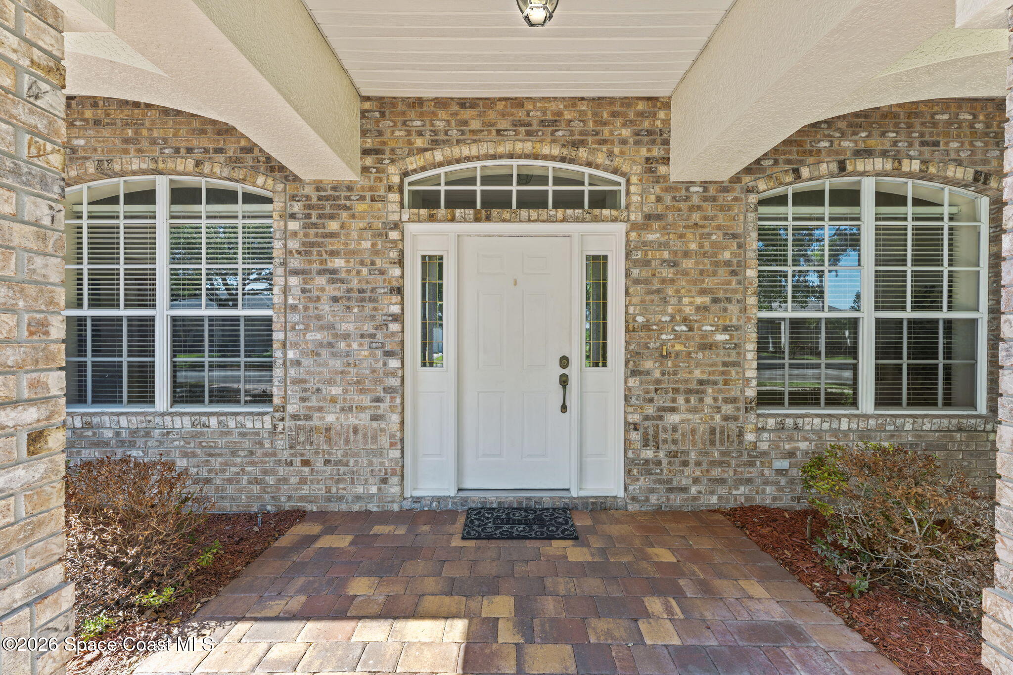 1123 Spring Oak Drive Melbourne, FL 32901 - Photo 9 of 67 a view of a brick house with many windows