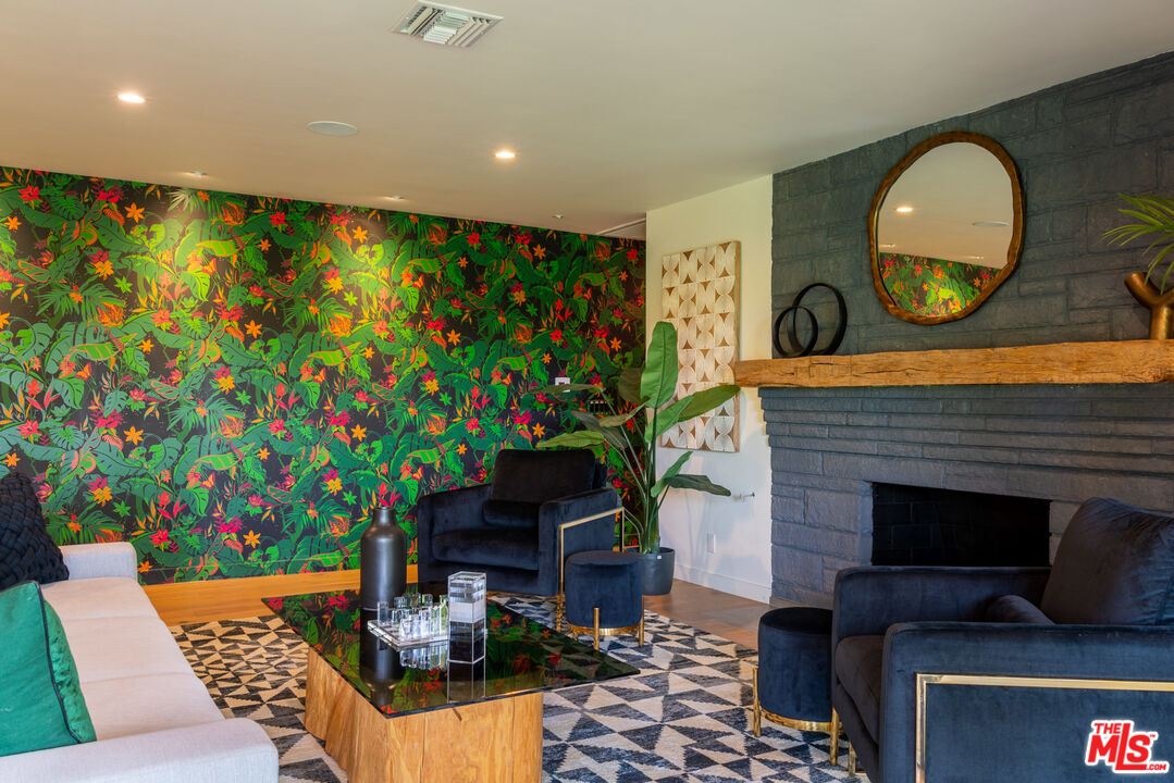 16666 Oldham Street Encino, CA 91436 - Photo 14 of 43 a living room with furniture and a flat screen tv