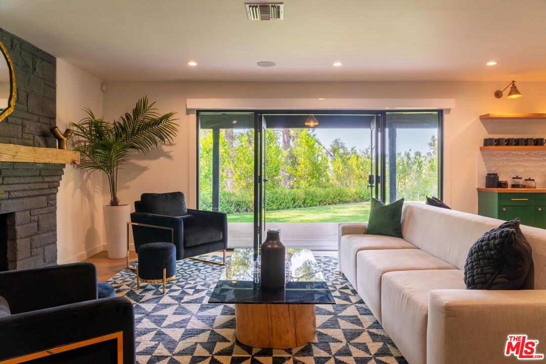 16666 Oldham Street Encino, CA 91436 - Photo 15 of 43 a living room with furniture and a large window