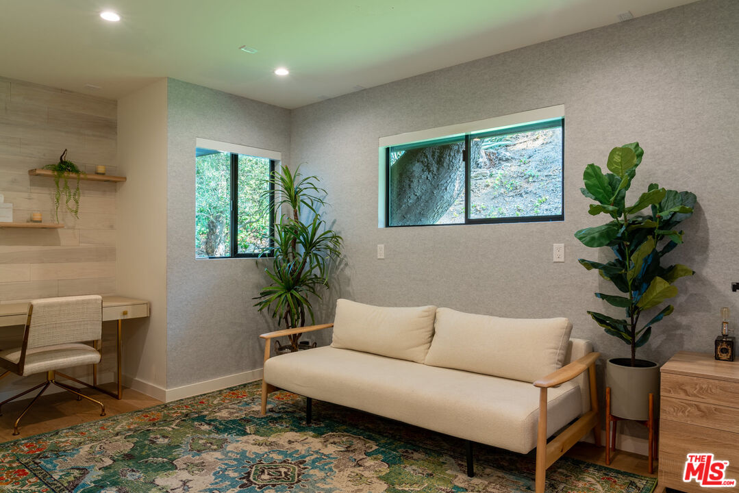 16666 Oldham Street Encino, CA 91436 - Photo 17 of 43 a living room with furniture a potted plant and a window