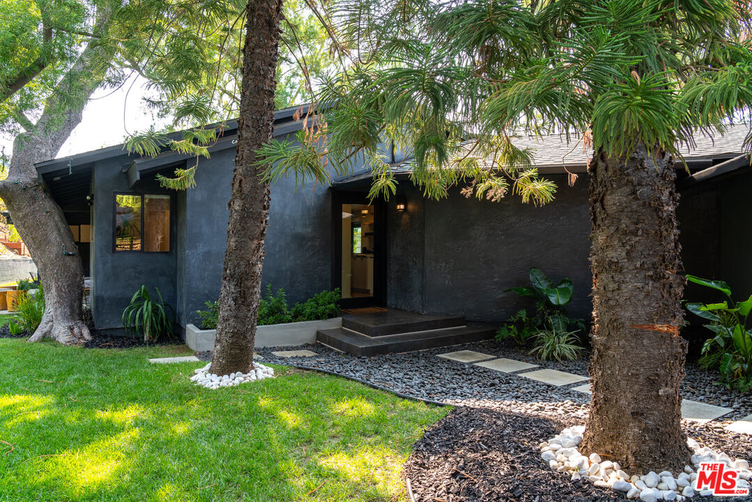16666 Oldham Street Encino, CA 91436 - Photo 3 of 43 a front view of a house with garden