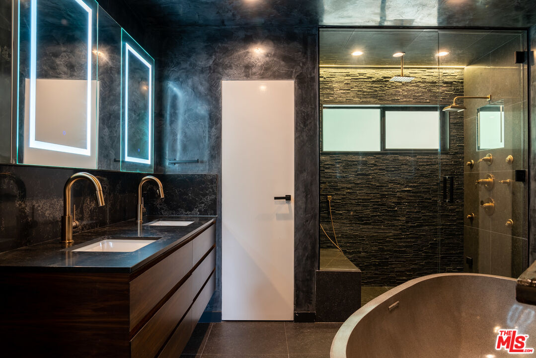 16666 Oldham Street Encino, CA 91436 - Photo 22 of 43 a bathroom with a sink and a mirror