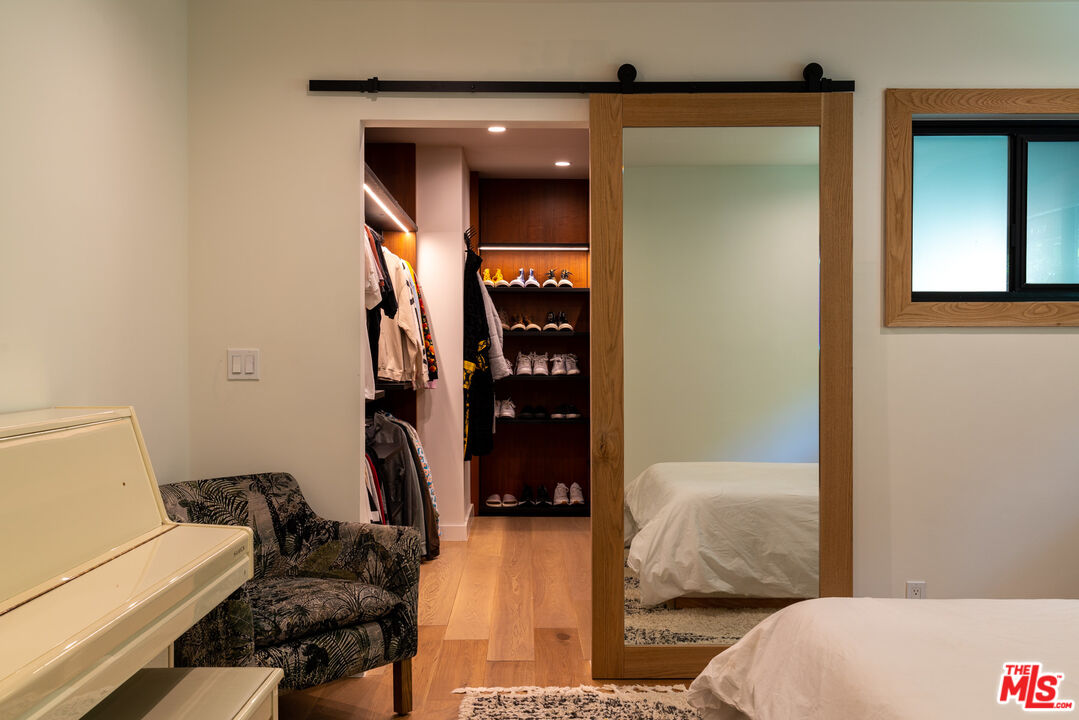 16666 Oldham Street Encino, CA 91436 - Photo 27 of 43 a bedroom with a bed and a cabinets