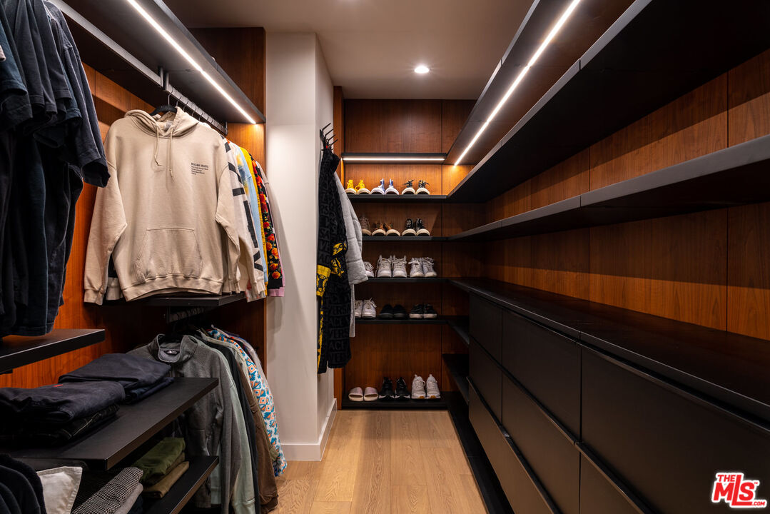 16666 Oldham Street Encino, CA 91436 - Photo 28 of 43 a view of walk in closet with clothes and shoes