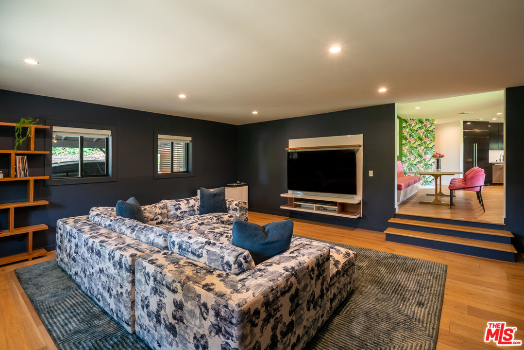 16666 Oldham Street Encino, CA 91436 - Photo 7 of 43 a living room with furniture and a flat screen tv