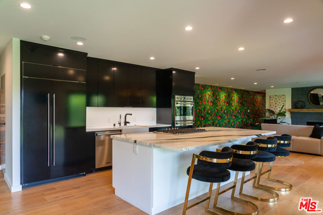 16666 Oldham Street Encino, CA 91436 - Photo 10 of 43 a kitchen with a sink and chairs