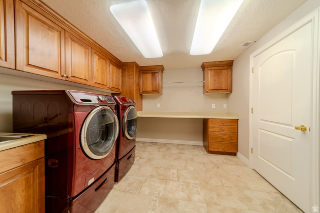 598 Hollow Creek Road Draper, UT 84020 - Photo 49 of 110 Dedicated laundry room featuring extensive upper cabinetry, a built-in countertop with integrated storage, and durable tile flooring