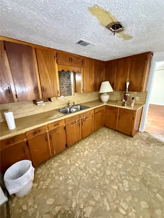 a kitchen with stainless steel appliances granite countertop a sink and cabinets