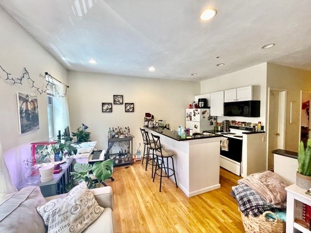 17 Thacher Street, Unit 3 Boston, MA 02113 - Photo 1 of 24 a kitchen with stainless steel appliances kitchen island granite countertop a refrigerator and a stove top oven
