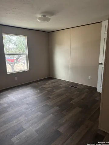 an empty room with windows and closet