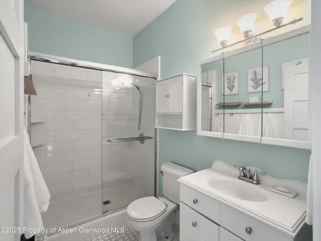 a bathroom with a sink toilet and shower
