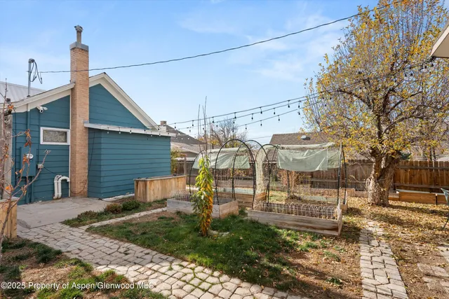 a front view of a house with a tree