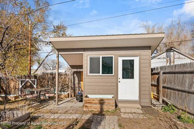 a view of a house with a small yard and wooden floor