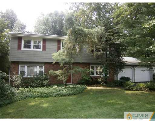 42 Clive Hills Road Edison, NJ 08820 - Photo 1 of 17 a front view of a house with garden