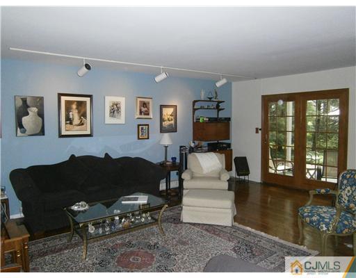 42 Clive Hills Road Edison, NJ 08820 - Photo 3 of 17 a living room with furniture and a window