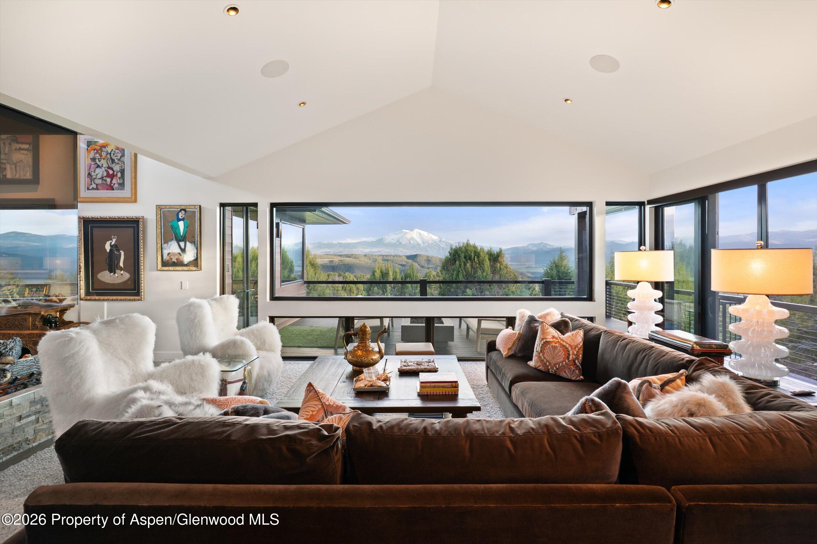 258 Monarch Road Glenwood Springs, CO 81601 - Photo 12 of 73 a living room with furniture large window and a flat screen tv