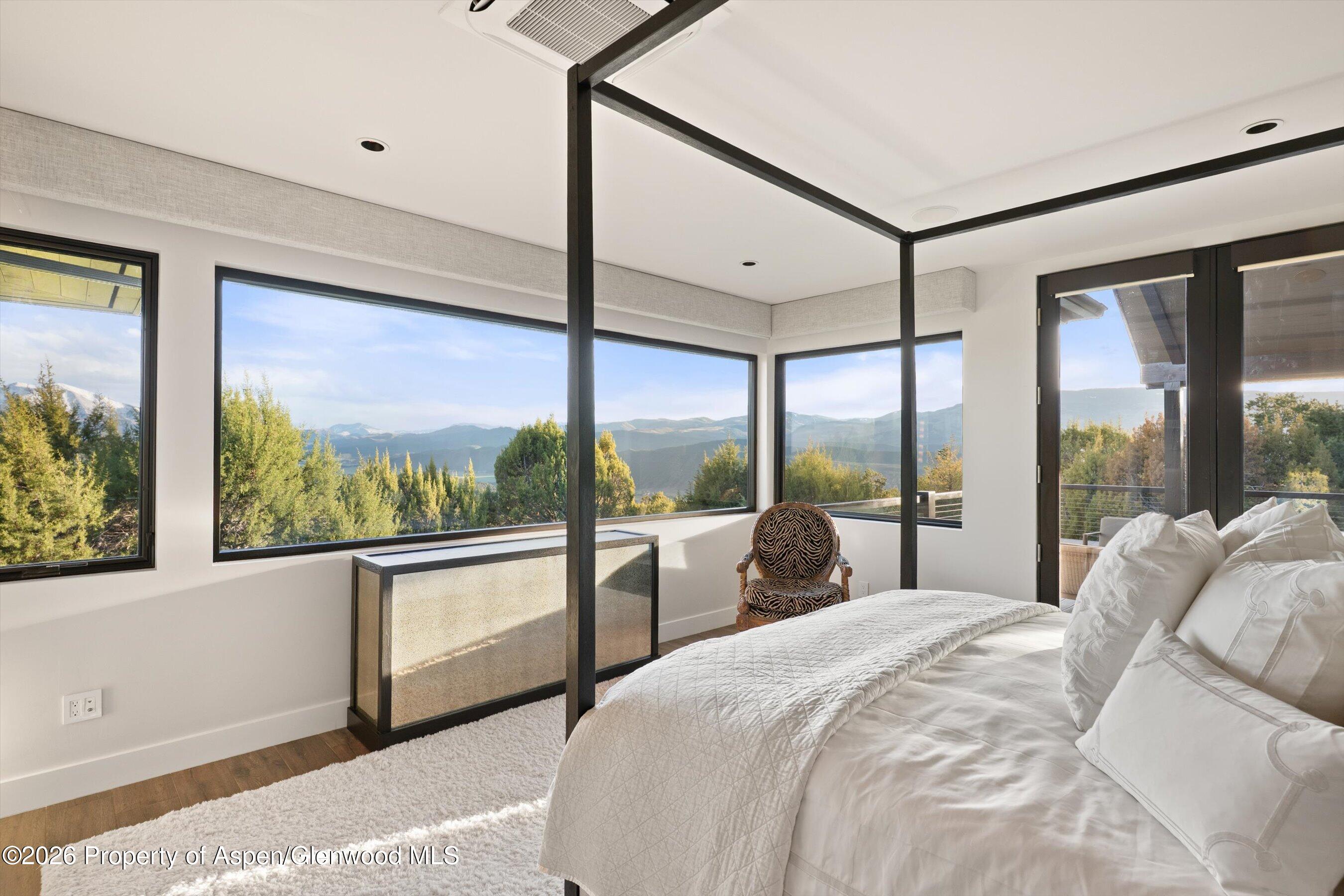 258 Monarch Road Glenwood Springs, CO 81601 - Photo 23 of 73 a large bedroom with a large window and a bed