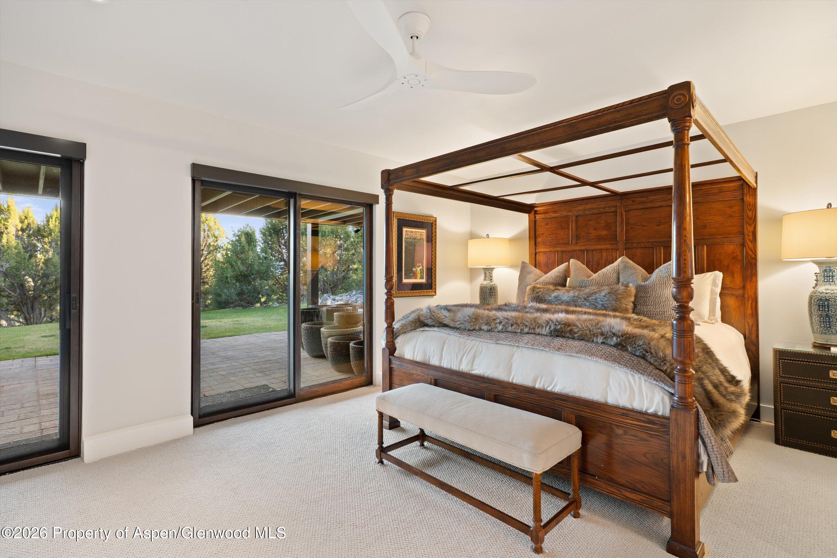 258 Monarch Road Glenwood Springs, CO 81601 - Photo 49 of 73 a bedroom with a bed and glass door